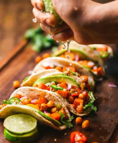 Beef tacos with cheese, lettuce, and tomato